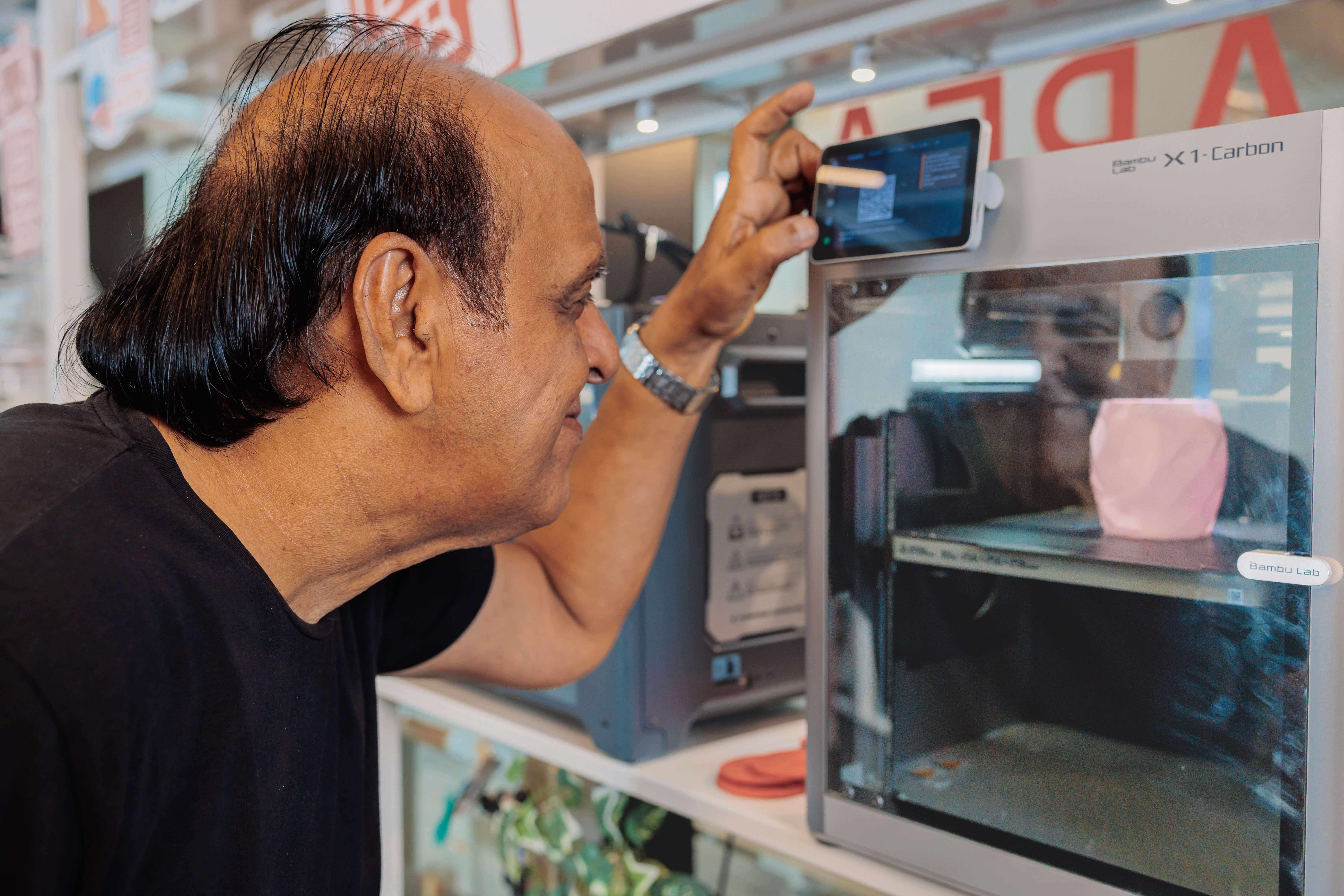 a maker at makeit using a bambu lab 3d printer