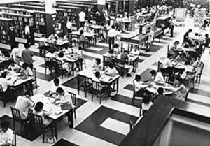 A black and white top view photograph of the well-patronised reading area in the library