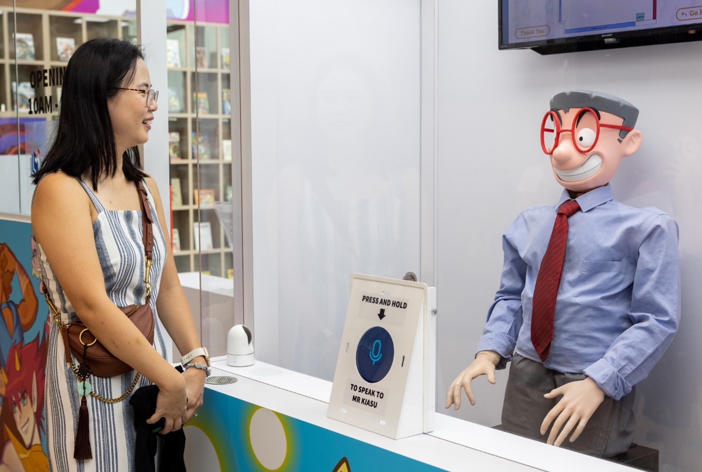 User interacting with Interactive life-size model of Mr Kiasu robot concierge